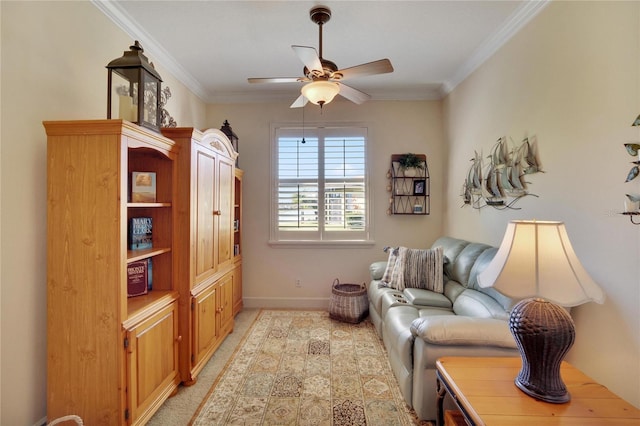 living area with ceiling fan and ornamental molding