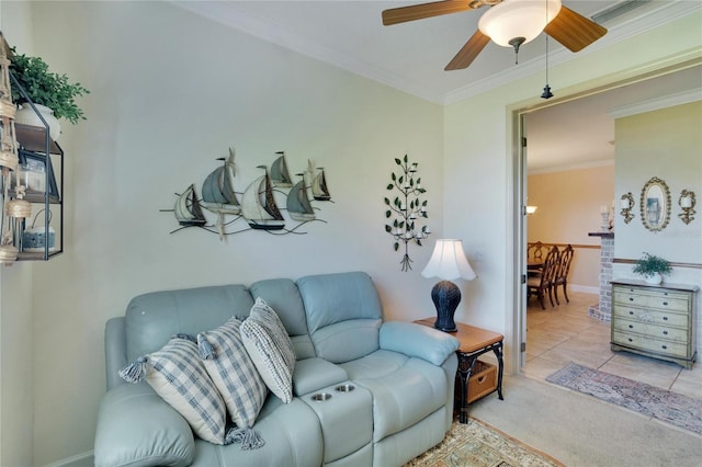 living room featuring light tile patterned floors, ceiling fan, and crown molding