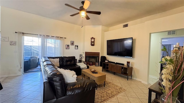 tiled living room featuring ceiling fan