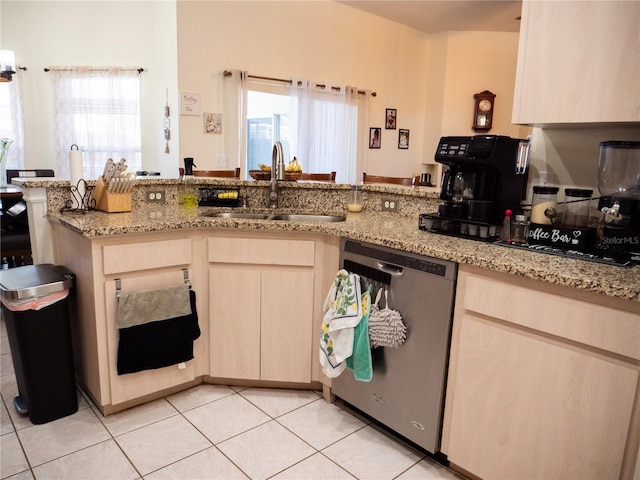 kitchen featuring light stone countertops, dishwasher, light brown cabinets, sink, and light tile patterned flooring