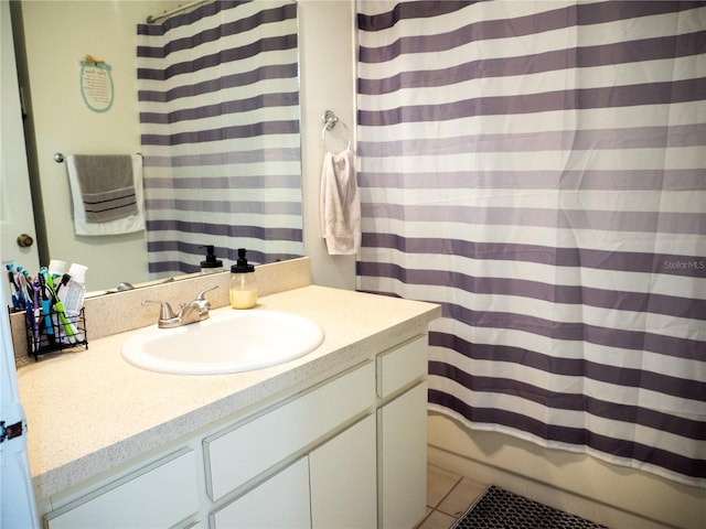 bathroom with tile patterned floors, vanity, and shower / tub combo