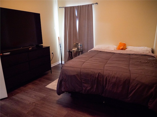 bedroom featuring dark hardwood / wood-style flooring