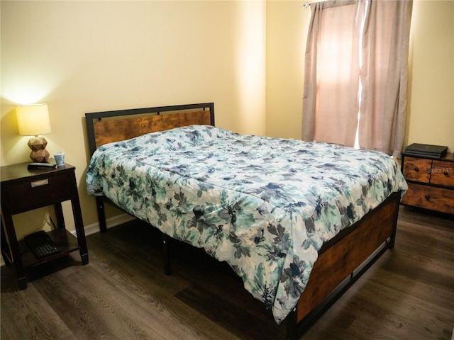 bedroom with dark wood-type flooring