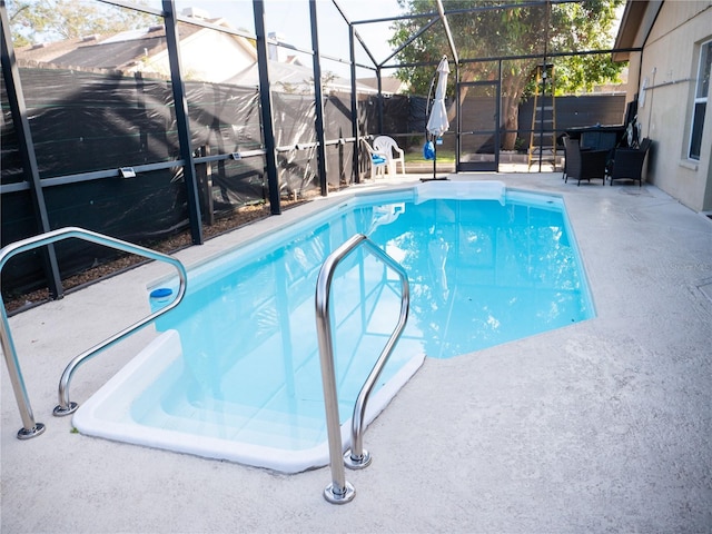 view of pool with a lanai and a patio area