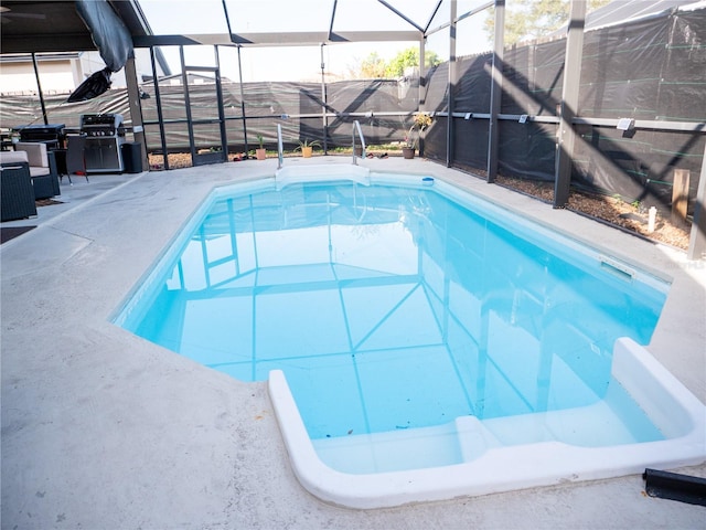 view of pool with a lanai and a patio