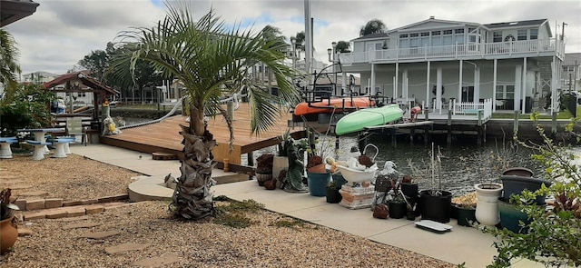 view of home's community with a boat dock and a water view