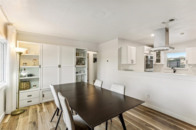 dining room with wood-type flooring and sink