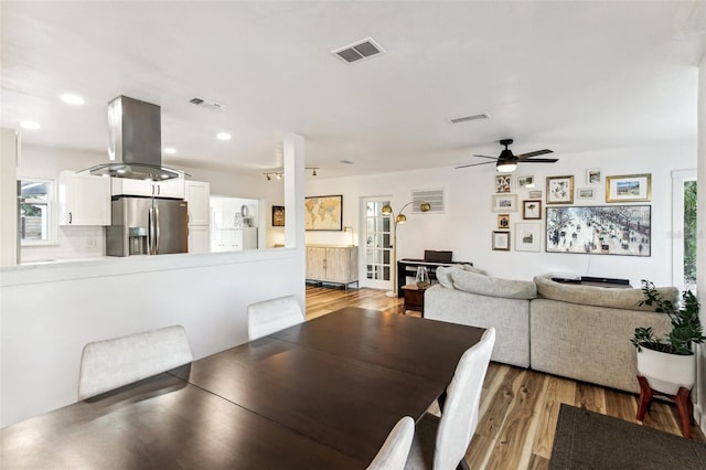 dining area with ceiling fan and light hardwood / wood-style flooring