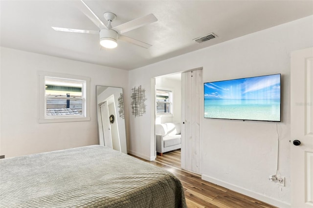 bedroom with ceiling fan and wood-type flooring