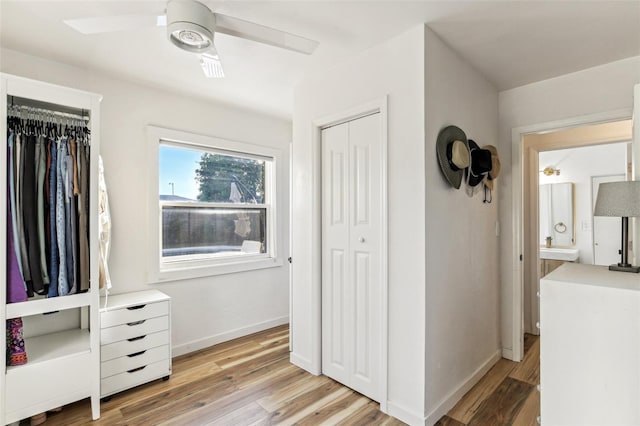 bedroom with ceiling fan, a closet, and light hardwood / wood-style floors