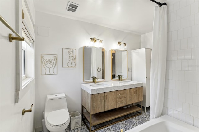 full bathroom with shower / tub combo with curtain, vanity, and toilet