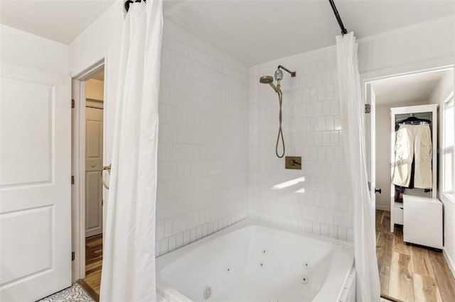 bathroom featuring wood-type flooring and shower / bathtub combination with curtain