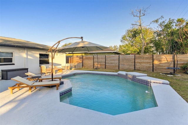 view of pool with pool water feature and a patio area