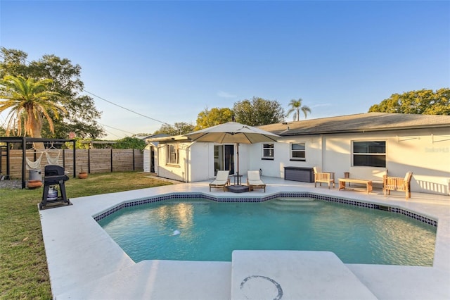 view of pool featuring a patio area and a lawn