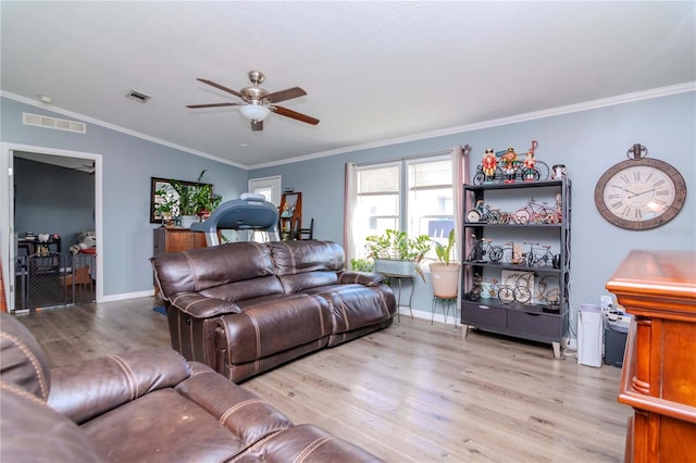 living room featuring light wood-type flooring, vaulted ceiling, ceiling fan, and crown molding