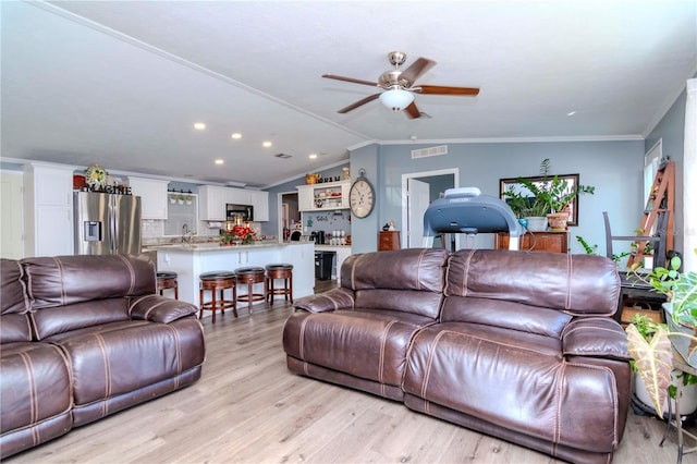 living room with ceiling fan, light hardwood / wood-style floors, lofted ceiling, and crown molding