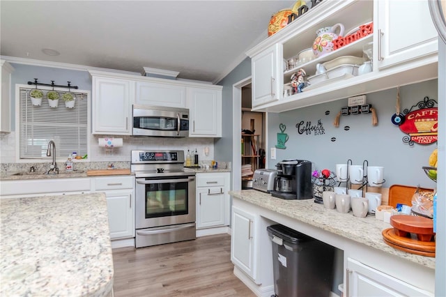 kitchen featuring white cabinets, crown molding, sink, and appliances with stainless steel finishes