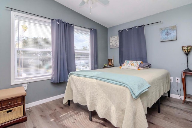 bedroom featuring ceiling fan, wood-type flooring, and lofted ceiling