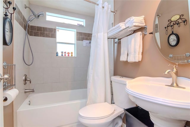 full bathroom with shower / tub combo, toilet, and sink