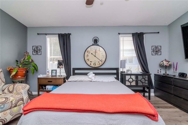 bedroom with ceiling fan and light wood-type flooring