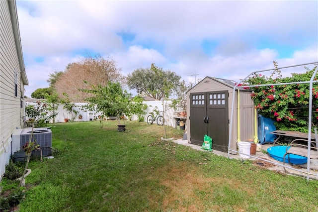 view of yard with a shed and central AC