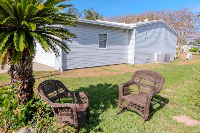 view of yard featuring central AC and a garage