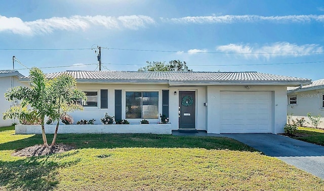 view of front of property featuring a garage and a front lawn