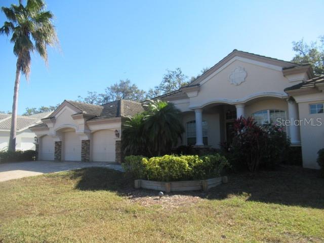 view of front of property with a garage and a front lawn