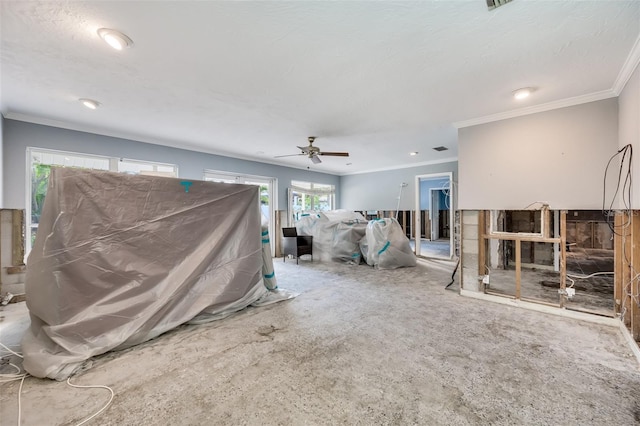 living room featuring a textured ceiling, ceiling fan, ornamental molding, and carpet floors