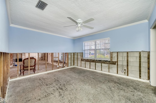 carpeted spare room with a textured ceiling, ceiling fan, and crown molding