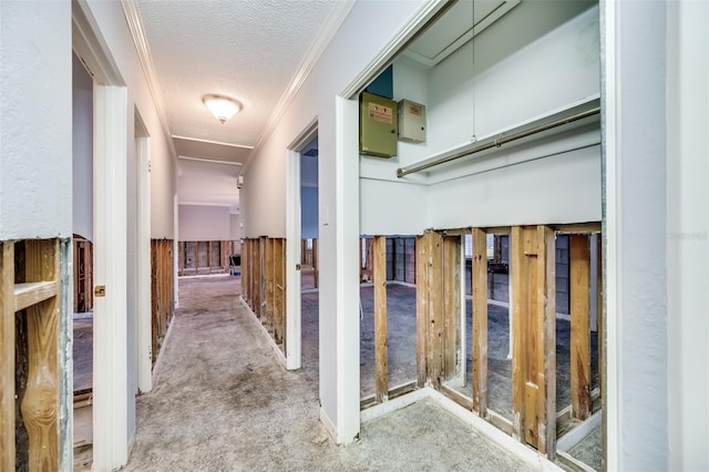 corridor with light carpet, a textured ceiling, and ornamental molding