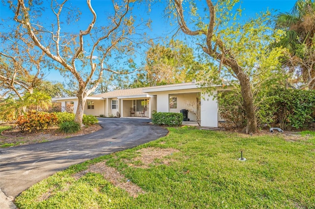 ranch-style home featuring a front lawn