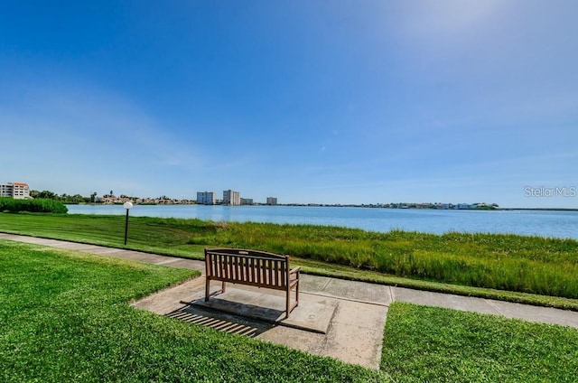 view of community with a water view and a yard