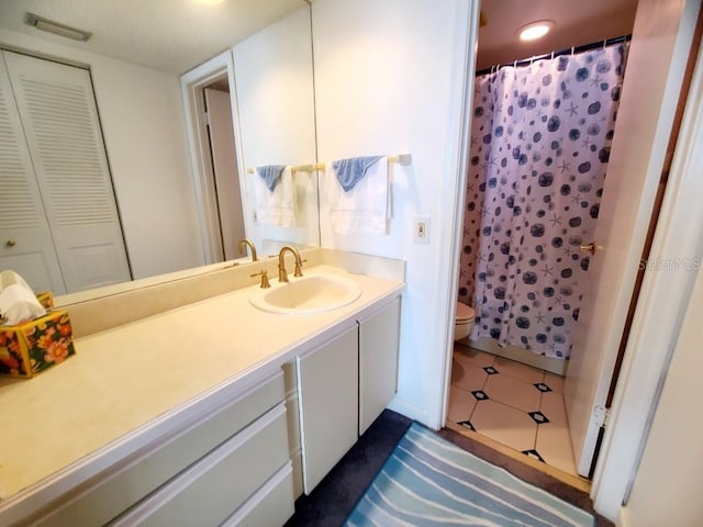 bathroom with toilet, vanity, and a shower with shower curtain