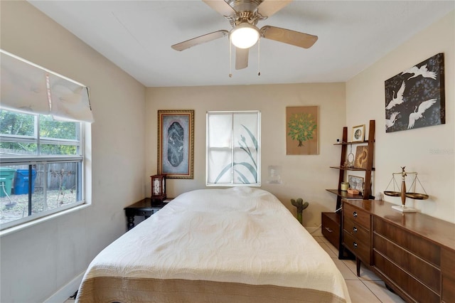 tiled bedroom featuring ceiling fan