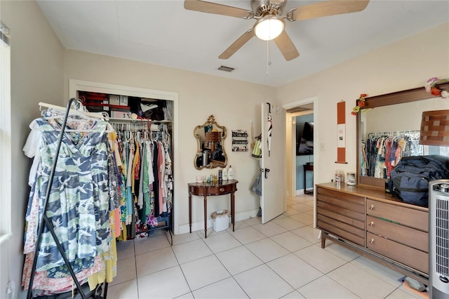 tiled bedroom featuring a closet and ceiling fan