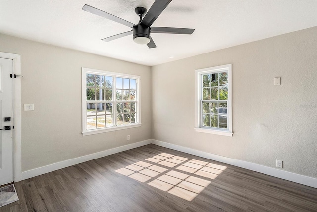 spare room featuring dark hardwood / wood-style floors and ceiling fan