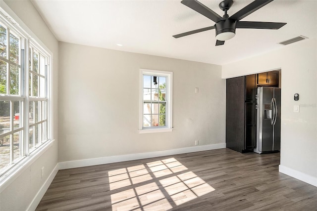 empty room featuring ceiling fan and dark wood-type flooring