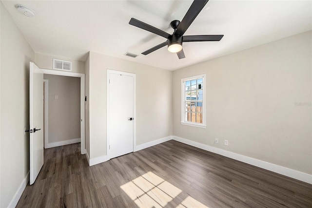 unfurnished bedroom featuring ceiling fan, dark hardwood / wood-style flooring, and a closet