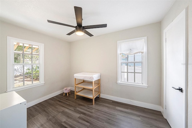 miscellaneous room with ceiling fan and dark hardwood / wood-style flooring