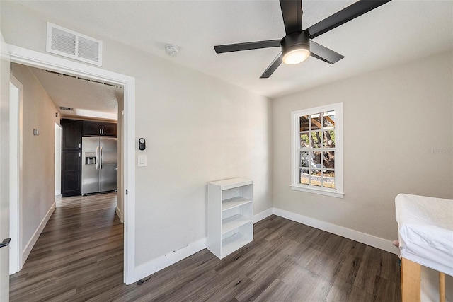 interior space featuring ceiling fan and dark hardwood / wood-style floors