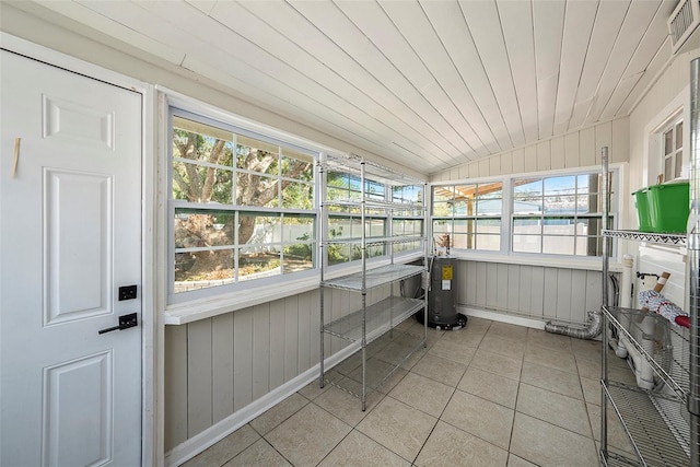 sunroom with electric water heater and wooden ceiling