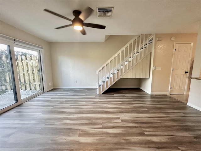 interior space with ceiling fan and wood-type flooring