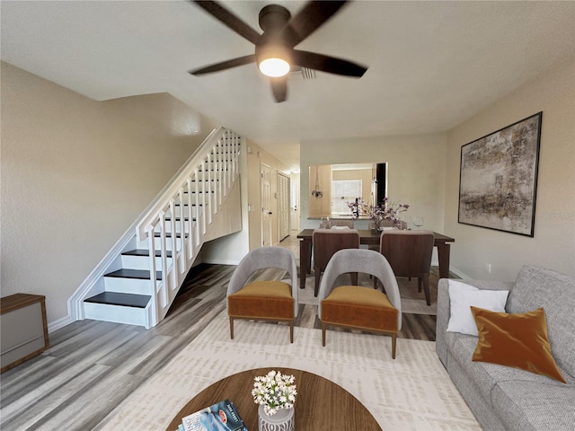 living room with wood-type flooring and ceiling fan