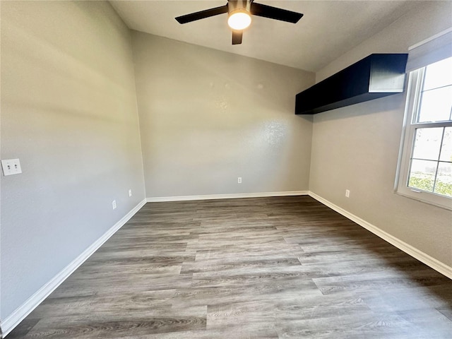 unfurnished room featuring ceiling fan, baseboards, and wood finished floors