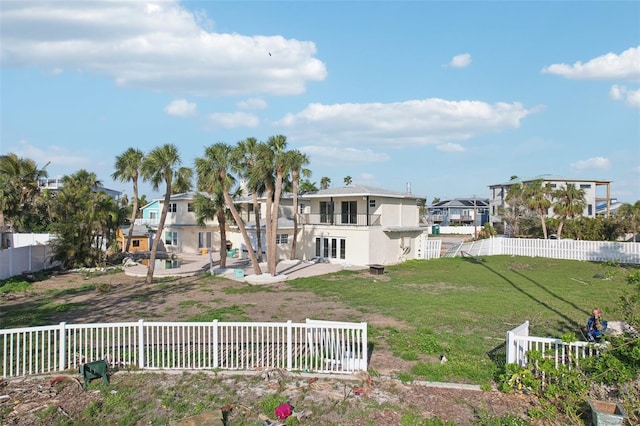 back of property featuring a lawn