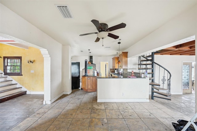 kitchen featuring tasteful backsplash, kitchen peninsula, ceiling fan, and decorative light fixtures