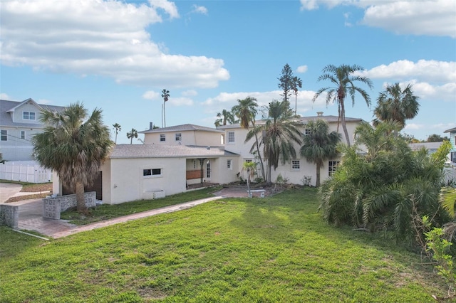 rear view of house featuring a yard