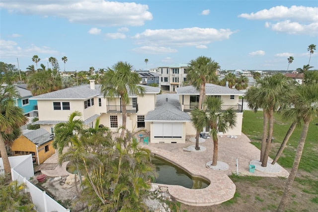 view of front of property featuring a patio area and a balcony