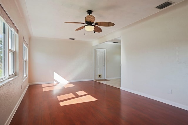 empty room with ceiling fan and light hardwood / wood-style flooring